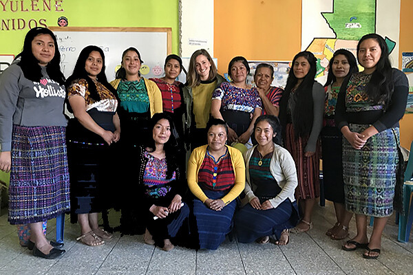 Briana Nichols stands among a group of twelve people in Guatemala.
