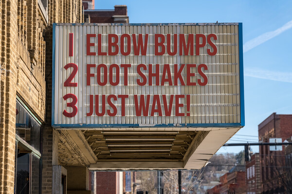 A movie marquee with the words "1. Elbow Bumps 2. Foot Shakes 3. Just Wave!"