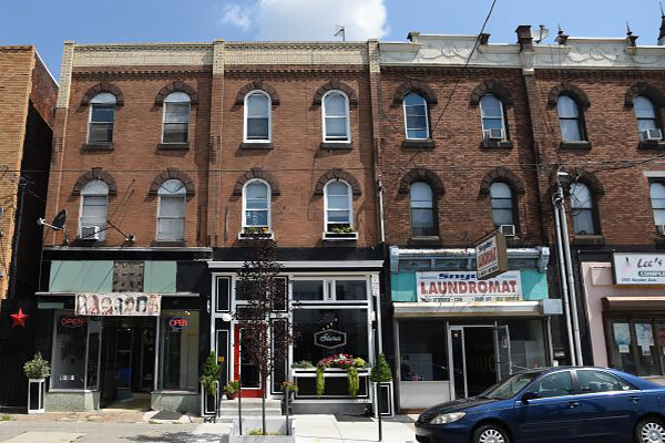 Philadelphia rowhouses with small businesses at street level.