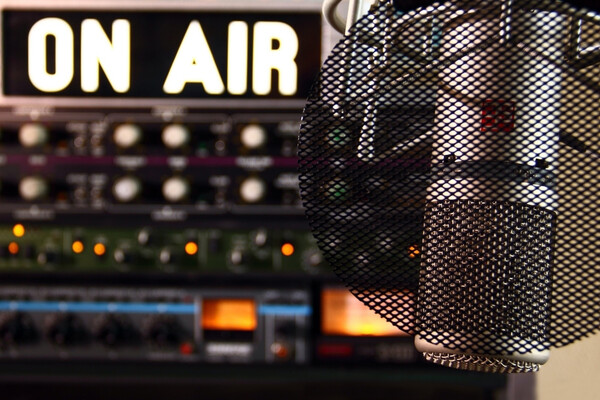 Radio microphone and a soundboard with an ON AIR sign.