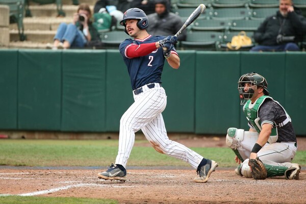 At Meiklejohn Stadium against Dartmouth, junior utility player Ben Miller swings at a pitch.