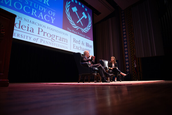 John Bolton sits on a stage at Irvine Auditorium with the president of the Penn Political Union
