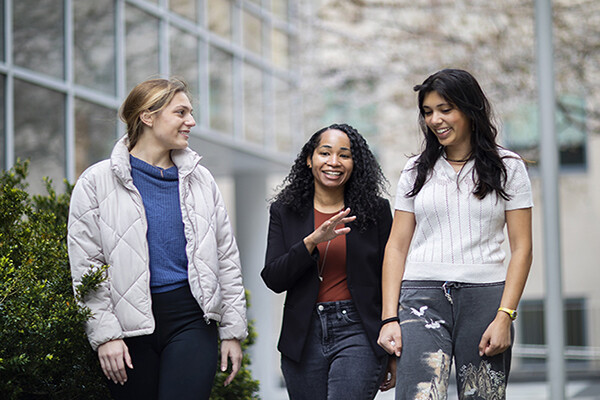 Lacey Rivera, Rashida Ng, and Sonia Shah talking and walking outside.