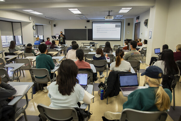 students in a classroom watching a guest speaker