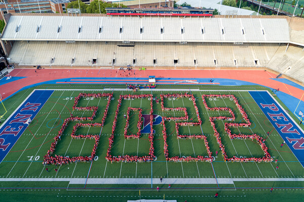 Aerial view of Franklin Field with bodies arranged to spell out 2022.