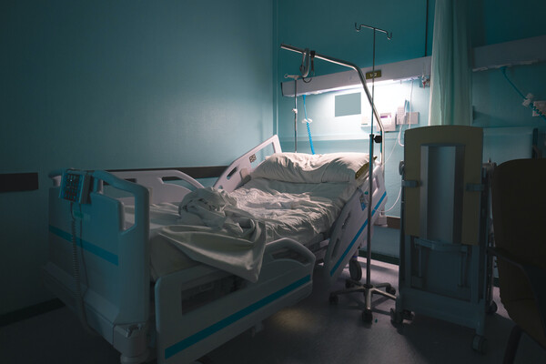 An empty hospital bed in a hospital room. 