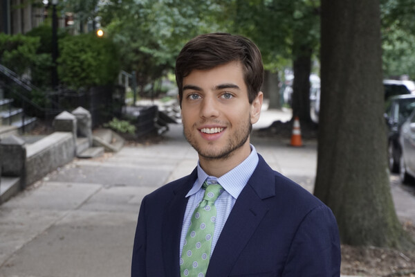 Ethan Kallett standing outside on a sidewalk 