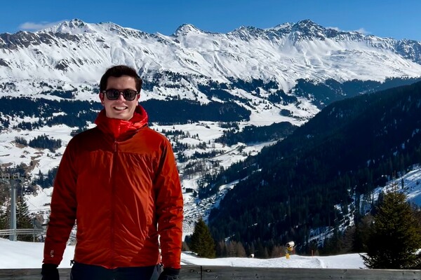 Ricardo Del Rio standing outside with snow-covered mountains behind him 