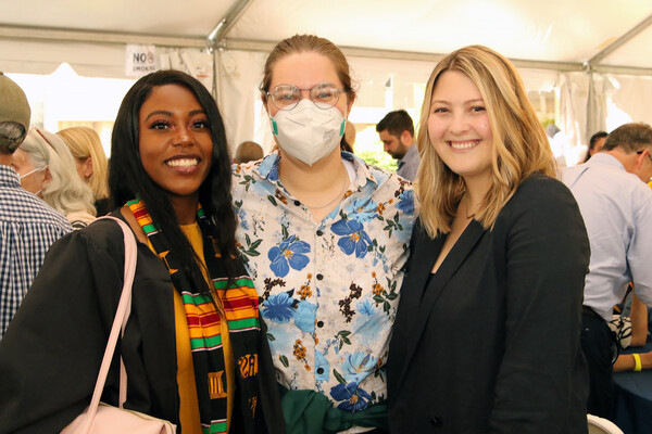 Gianni Morsell (left) and two other people smile for the camera at Commencement.