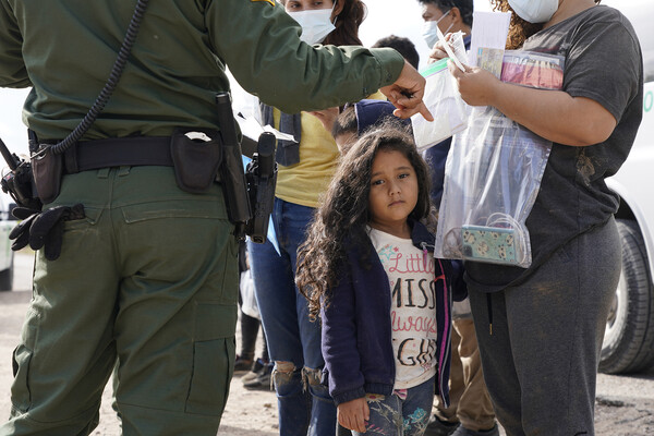 Small child being detained by U.S. Border Patrol.