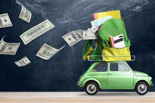 Car packed with school supplies on top of it and money falling out.