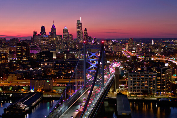 Skyline of the city of Philadelphia and Ben Franklin Bridge at dusk.