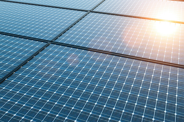 Solar panels with sunlight shining on the top right corner. 