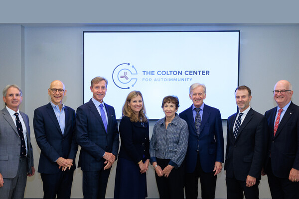 Eight people standing in front of a sign that reads The Colton Center for Autoimmunity, including E. John Wherry, Liz Magill, Larry Jameson, and Kevin Mahoney.