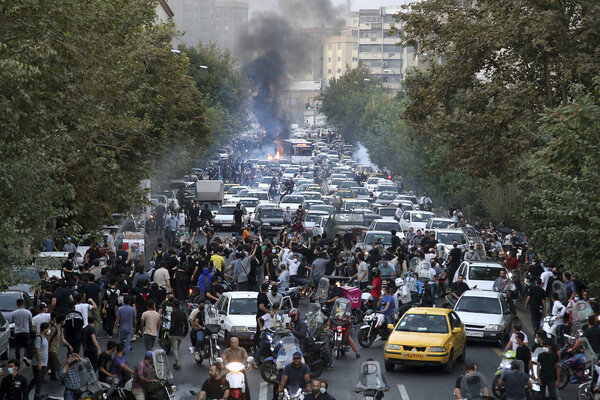 Protesters and cars jam a street in Tehran, Iran.