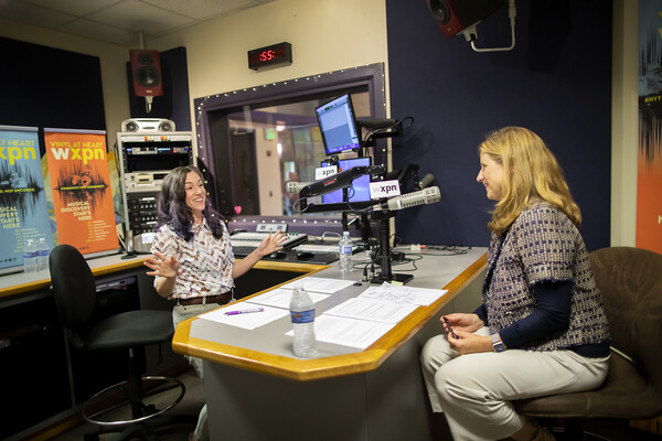 Kristen Kurtis and Liz Magill talking in recording studio