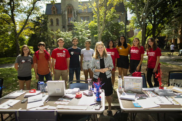 Penn President Liz Magill stands with members of Penn Leads the Vote in front of a voter registration table on College Green.