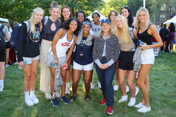 President Magill, center wearing a Penn hat, poses with female student-athletes.