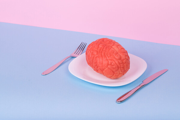 A brain on a plate with a fork and knife set out.