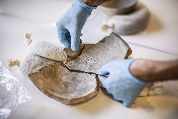 penn museum incantation bowl being examined