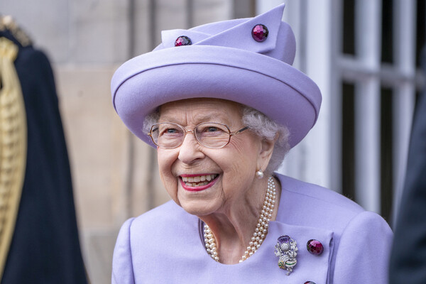 Queen Elizabeth II, smiling.