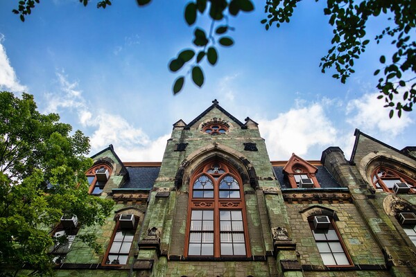 college hall with blue skies