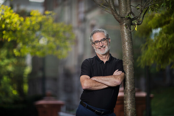 Rob Fleming leans on a tree on Penn’s campus.