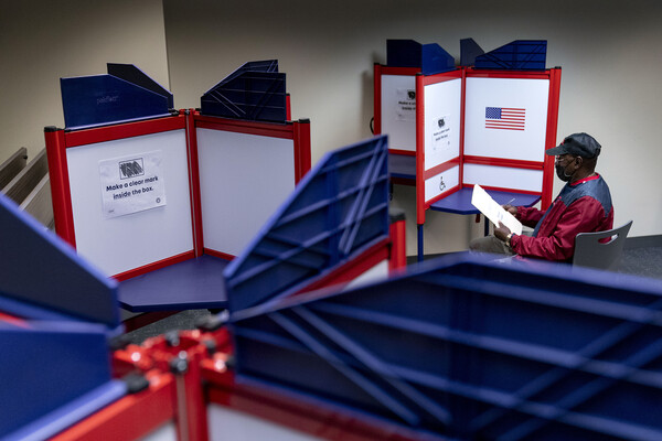 A man fills out his ballot at an early voting location in Alexandria Virginia.
