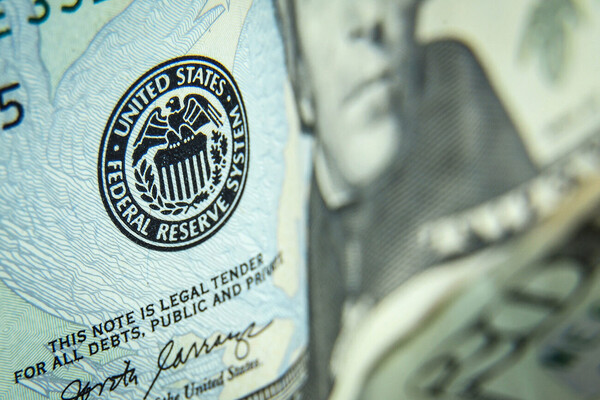 Closeup of a twenty dollar bill with the Federal Reserve System stamp highlighted.