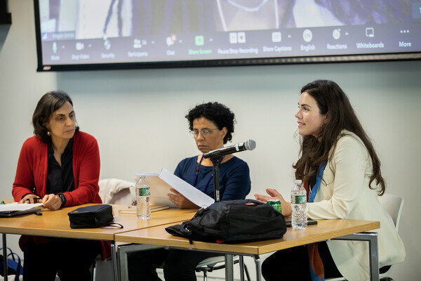 Tulia Falleti, Melissa Teixeira, and Marilene Felinto seated at a table addressing an audience.