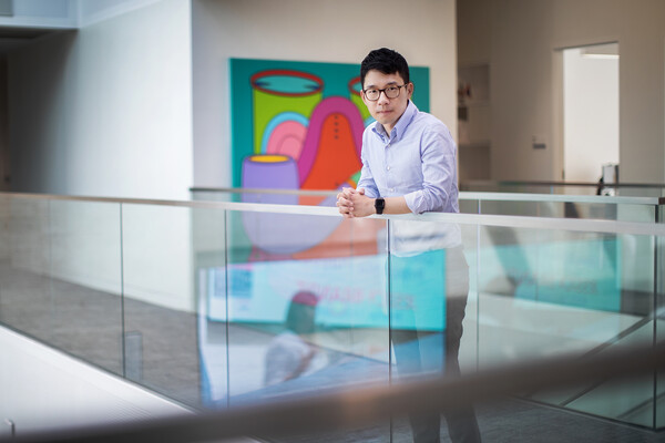 Activist Nathan Law poses in front of a painting in Perry World House