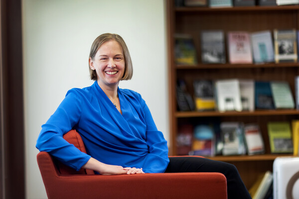 Emily Largent smiles in a chair