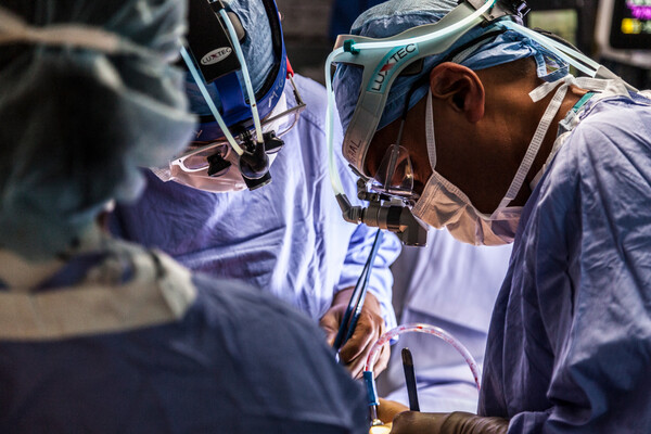 Three surgeons performing surgery.