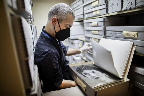 worker reviewing orchestra archives