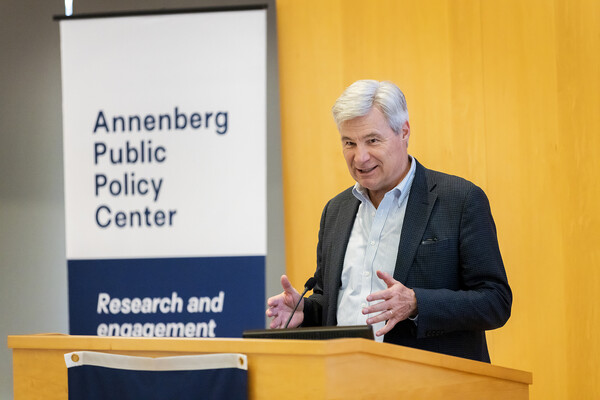 Senator Sheldon Whitehouse speaks at a podium in the Annenberg Public Policy Center