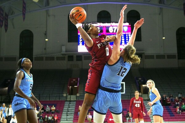 Against Columbia at the Palestra, forward Jordan Obi goes up for the shot while guarded by a defender.