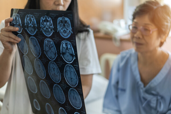Doctor and patient looking at results of a brain scan.