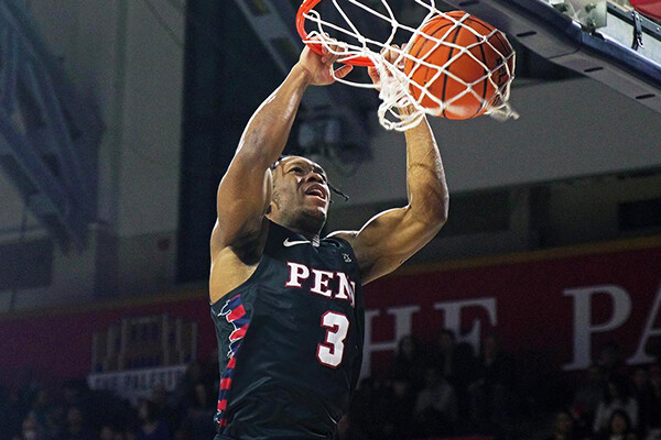 During a game at the Palestra, guard Jordan Dingle dunks the ball with two hands.