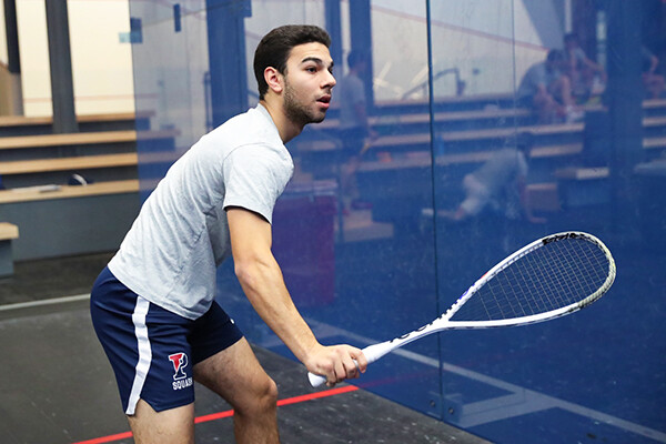 At the Penn Squash Center, Omar Hafez prepares to swing at the ball during a match.