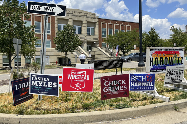 Campaign signs dot a lawn outside a Tennessee polling location.