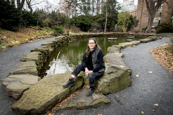 Person poses by the Biopond on Penn's campus