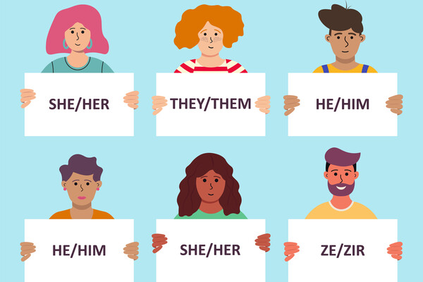 Six people holding up signs with their pronouns.