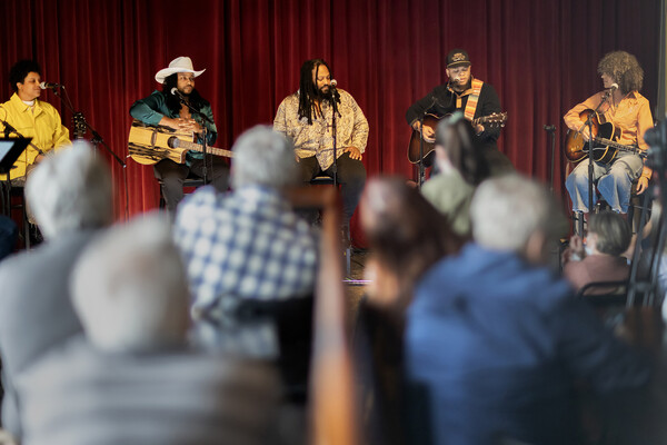 A band seated on stools performs to a small audience in WXPN’s studio.