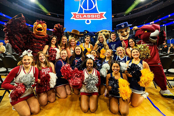 At the Wells Fargo Center, Big 5 cheerleaders and mascots pose at center court.