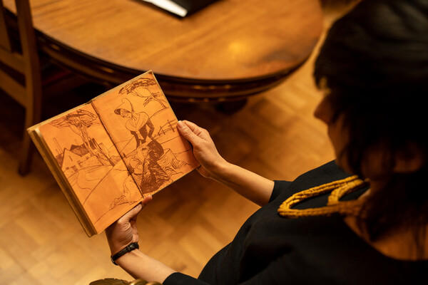 Sonal Khullar inspects the flyleaf from 'Alice in Wonderland.'