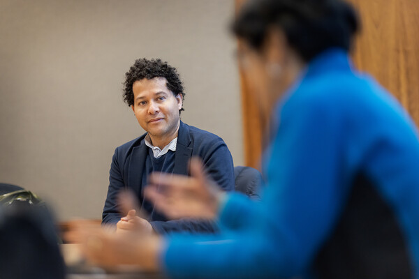 Juan Castrillon speaking in a classroom