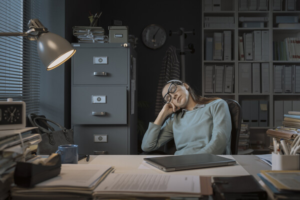 Person asleep at an office desk.
