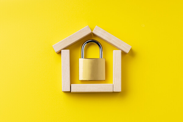 A small lock inside toy blocks in a house shape.