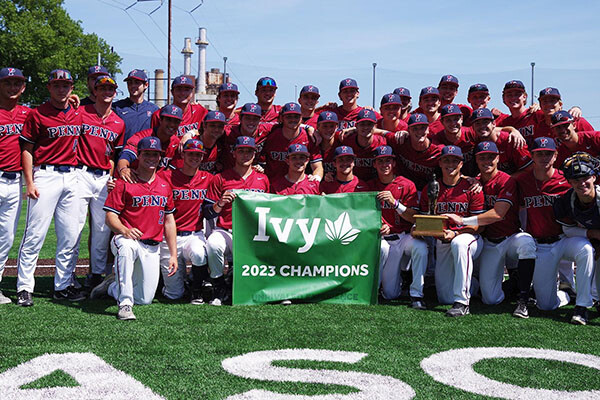 After sweeping Columbia at home, members of the baseball team pose with the Ivy League championship banner.