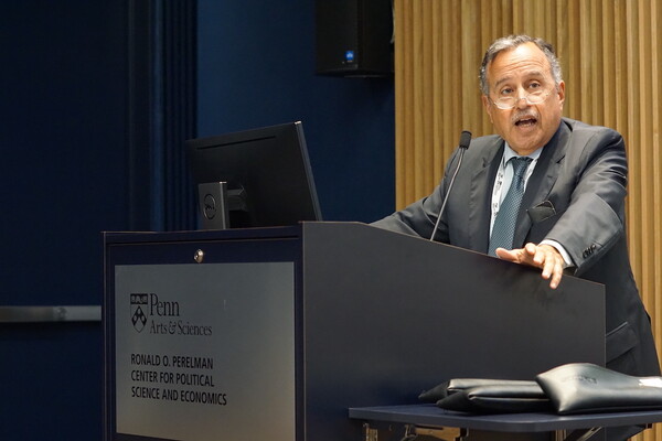 Former Egyptian Ambassador to the U.S. Nabil Fahmy stands at a podium speaking into a microphone in an auditorium at the Perelman Center for Political Science and Economics on Penn's campus.